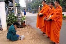 <p>Buddhist monks wearing orange robes, but also Thais wearing western clothes.</p>